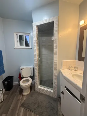 a bathroom with a sink toilet and shower