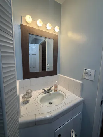 a bathroom with a sink and a mirror