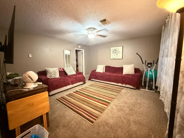 a bedroom with furniture and a window