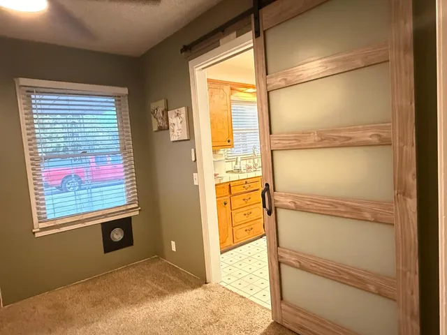a view of walk in closet with empty room