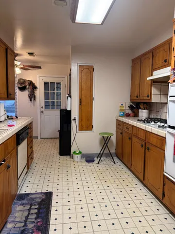 a kitchen with stainless steel appliances a stove a sink and a refrigerator