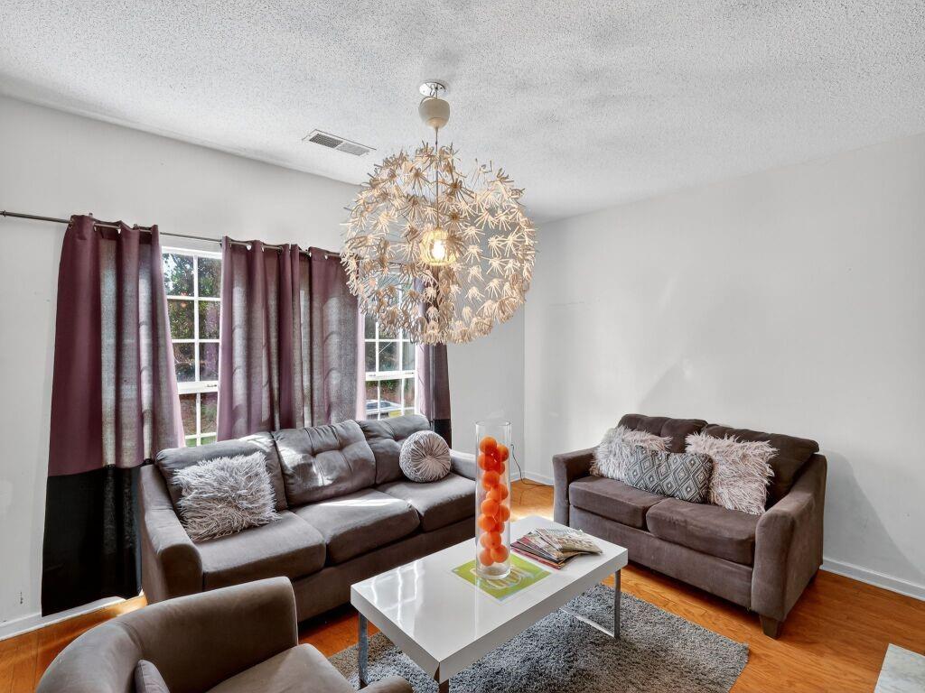 a living room with furniture a rug and a chandelier