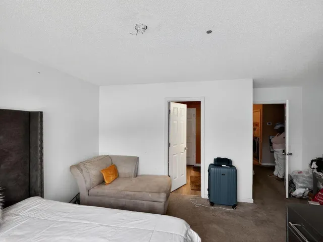 a bedroom with a bed and a mirror