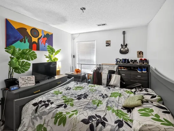 a bed room with bed and a window