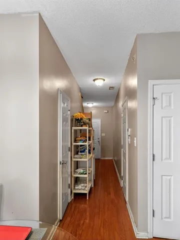a view of empty room with wooden floor