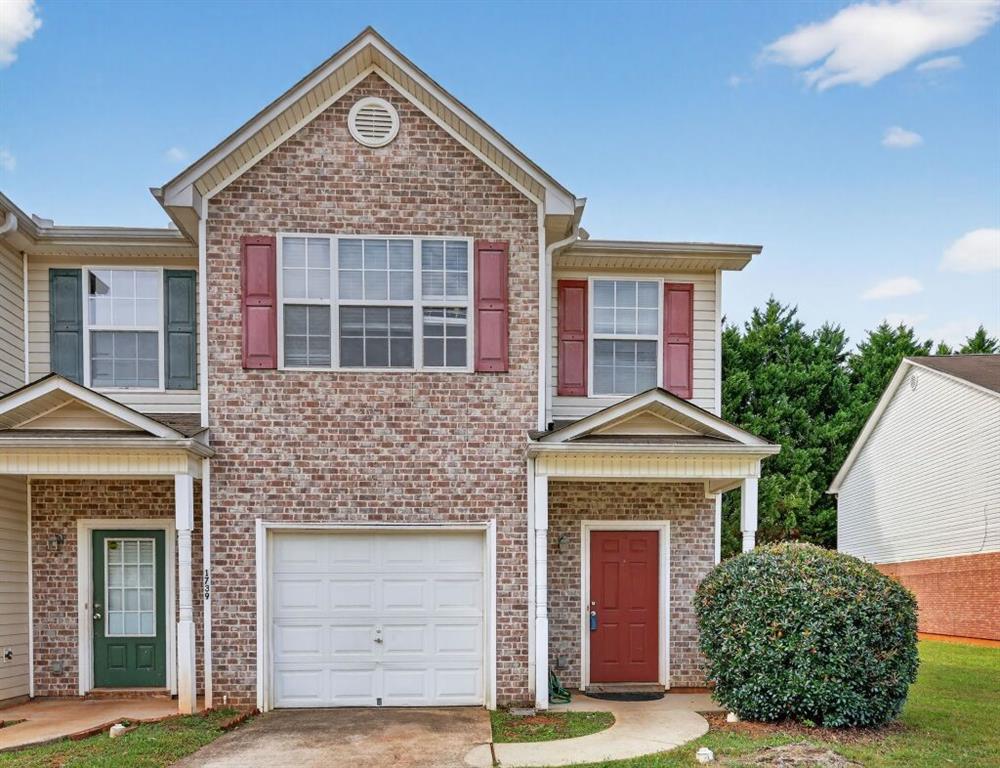 1737 Fielding Way Hampton, GA 30228 - Photo 4 of 17 a front view of a house with a garden