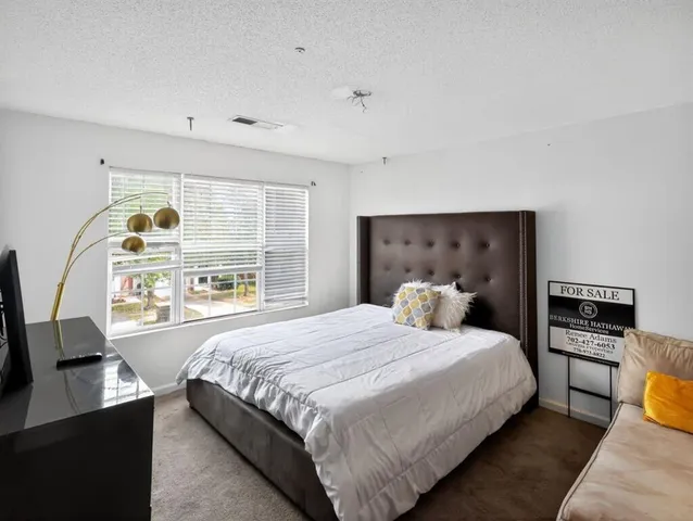 a bedroom with a large bed and a window