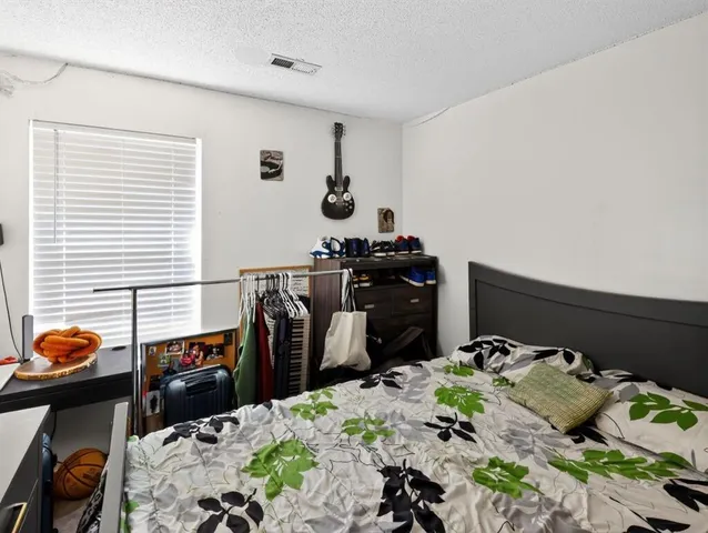 a bed room with a bed and a window