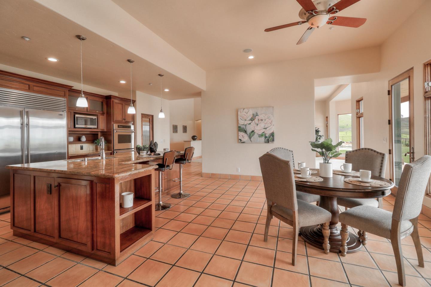 4280 Canada Road Gilroy, CA 95020 - Photo 37 of 50 a kitchen with stainless steel appliances kitchen island granite countertop a table chairs and a refrigerator