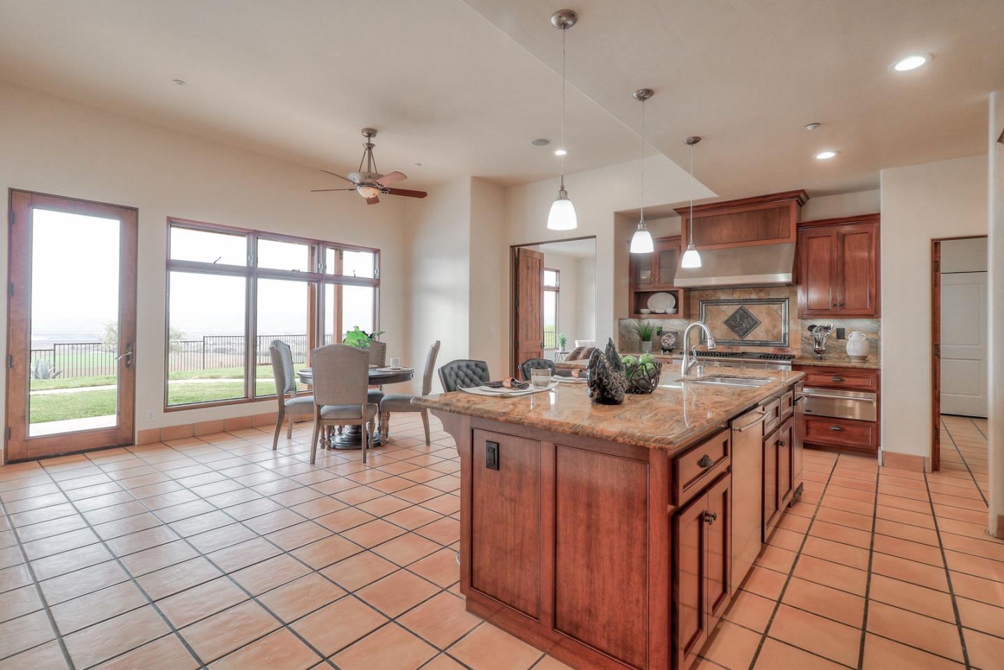 4280 Canada Road Gilroy, CA 95020 - Photo 39 of 50 a kitchen with stainless steel appliances granite countertop a stove top oven a sink dishwasher a dining table and chairs with wooden floor