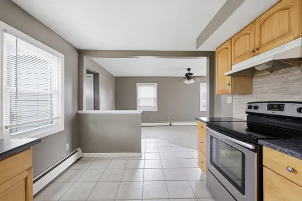 a kitchen with a stove a refrigerator and a sink
