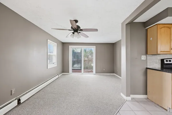 a view of an empty room with a kitchen