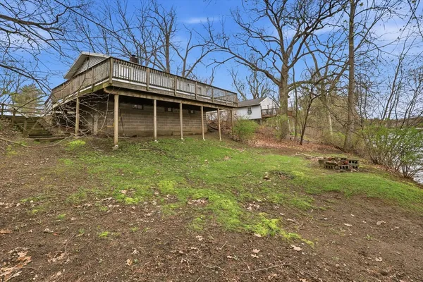a view of balcony with wooden floor and fence