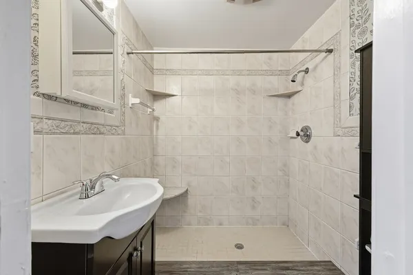 a bathroom with a sink a toilet and shower