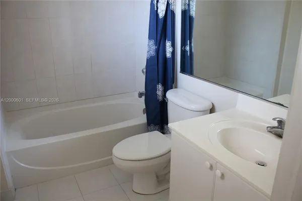 a white toilet sitting next to a bath tub