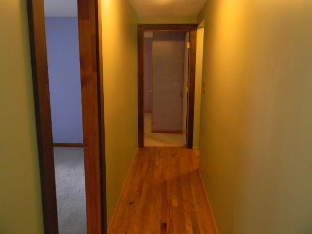 26 Keith Street Chelsea, ME 04330 - Photo 7 of 25 Hallway with laminate floors leading...