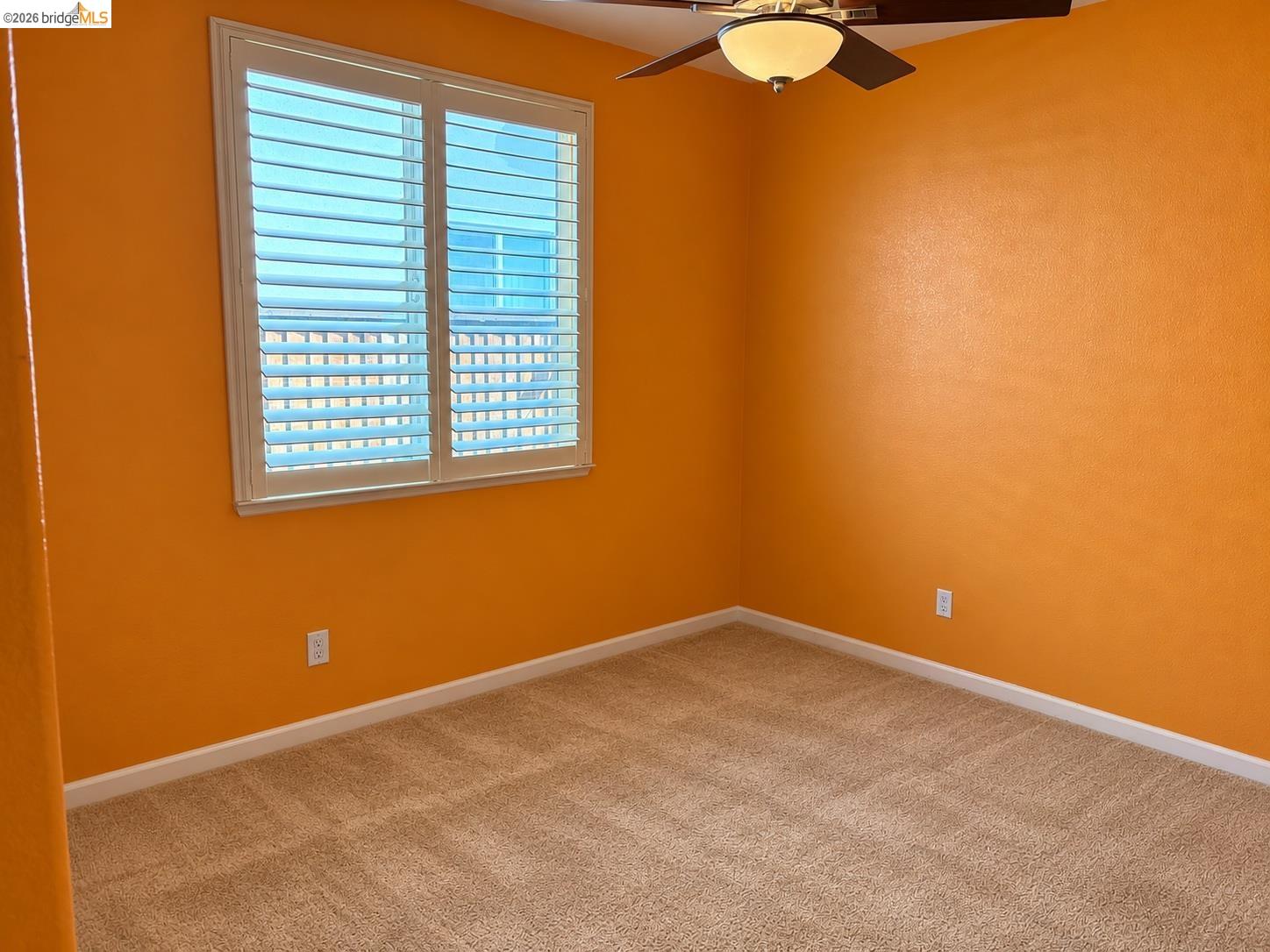 809 Ibis Road Oakley, CA 94561 - Photo 28 of 32 Window with white plantation shutters, neutral tone carpeting, and a ceiling fan with integrated lighting