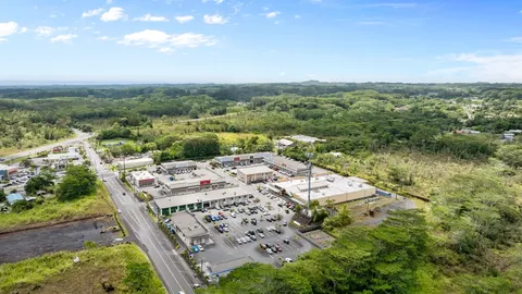 an aerial view of a residential houses with city view