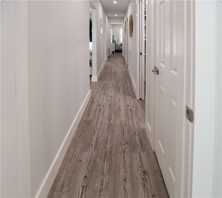 125 Lakewood Drive Mathis, TX 78368 - Photo 13 of 39 a view of a hallway with wooden floor and staircase