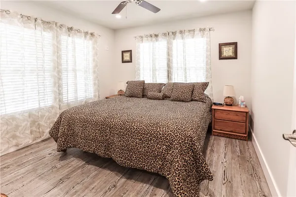 a bedroom with a bed and wooden floor