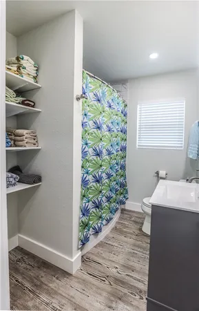 a room with a walk in closet and wooden floor