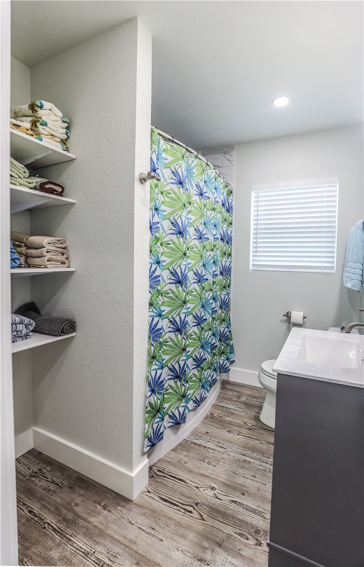 125 Lakewood Drive Mathis, TX 78368 - Photo 17 of 39 a room with a walk in closet and wooden floor