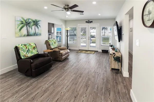 a living room with furniture and a wooden floor