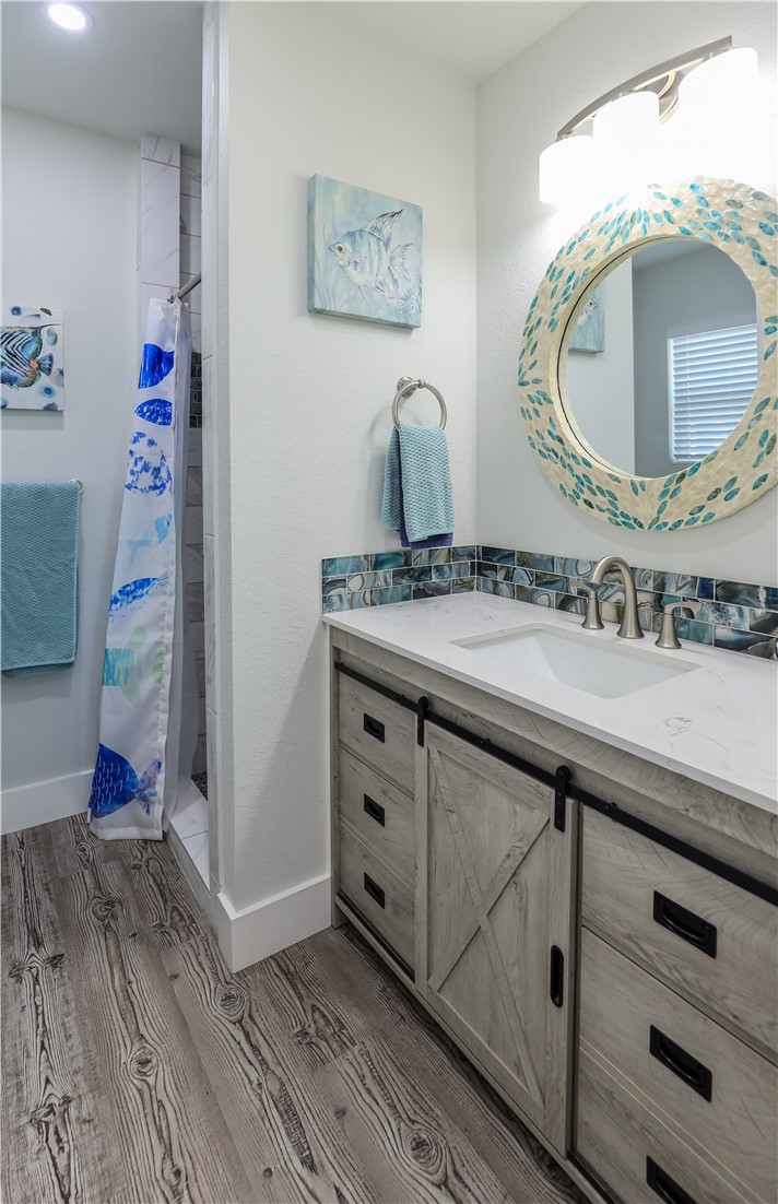 125 Lakewood Drive Mathis, TX 78368 - Photo 23 of 39 a bathroom with a double vanity sink mirror and toilet