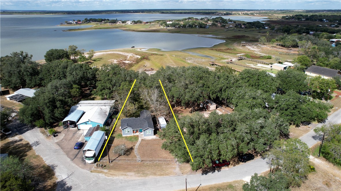 125 Lakewood Drive Mathis, TX 78368 - Photo 34 of 39 an aerial view of a house with a yard and lake view