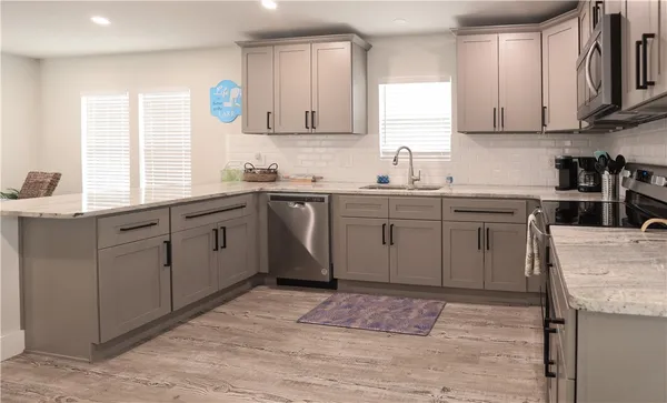 a kitchen with a sink stove and cabinets