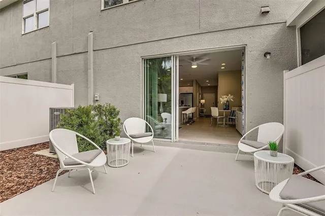 a outdoor space with a chair a couch and a potted plant
