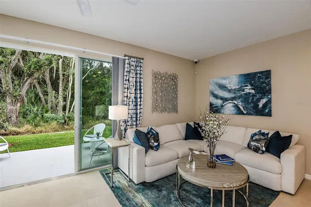 a living room with furniture and a large window