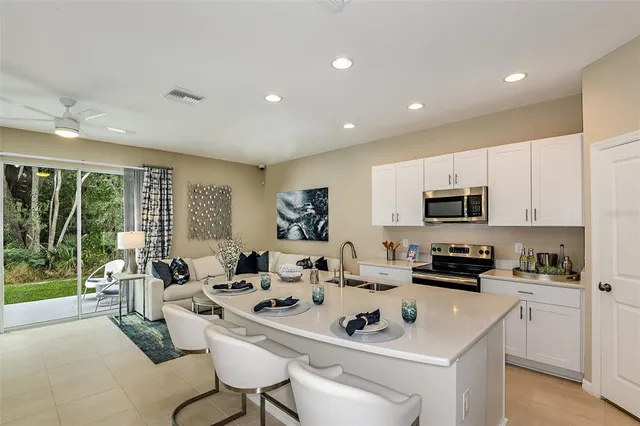 a kitchen with stainless steel appliances kitchen island granite countertop a sink and cabinets