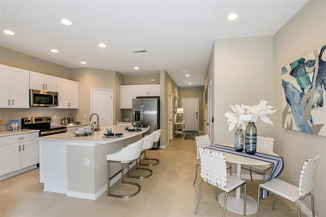 a kitchen with stainless steel appliances kitchen island granite countertop a sink and cabinets