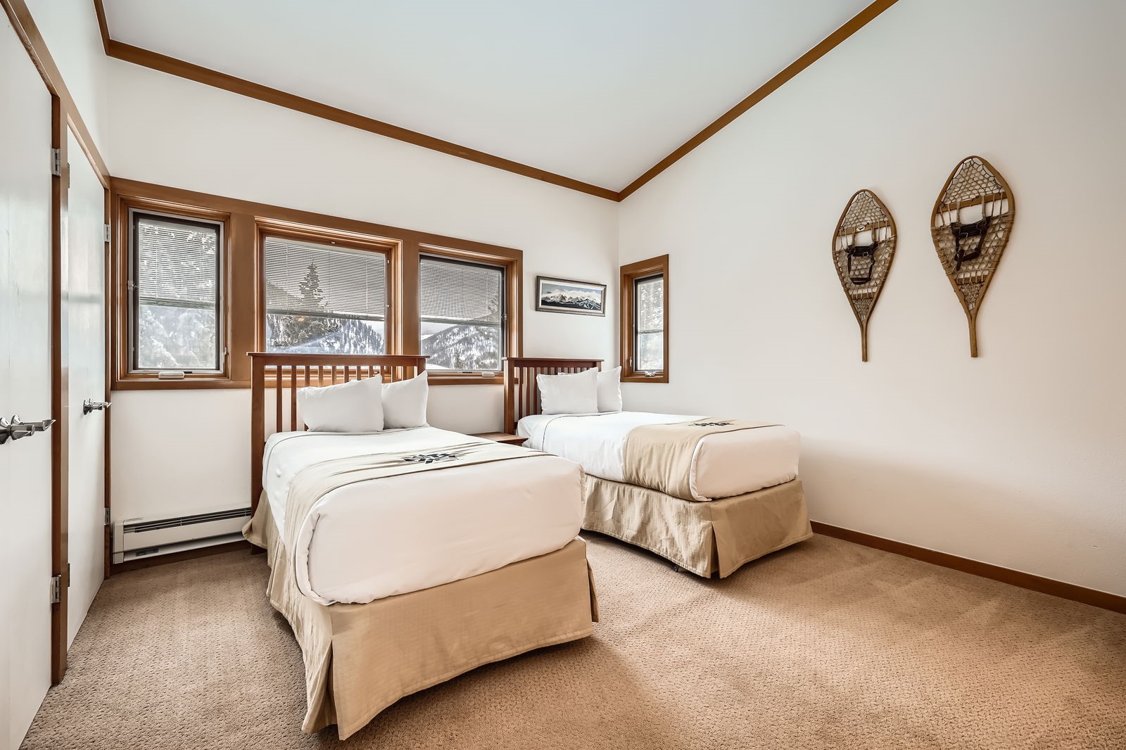 440 Tennis Club Road, Unit 1321 Keystone, CO 80435 - Photo 16 of 42 A generously sized second bedroom with a wall of windows and vaulted ceilings, offering a bright and open ambiance