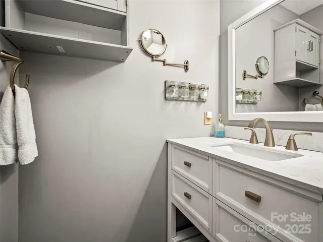 a living room with furniture and a kitchen view