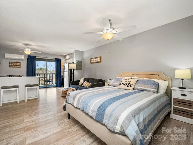 a kitchen with stainless steel appliances granite countertop a stove top oven a refrigerator a sink and a dining table with wooden floor