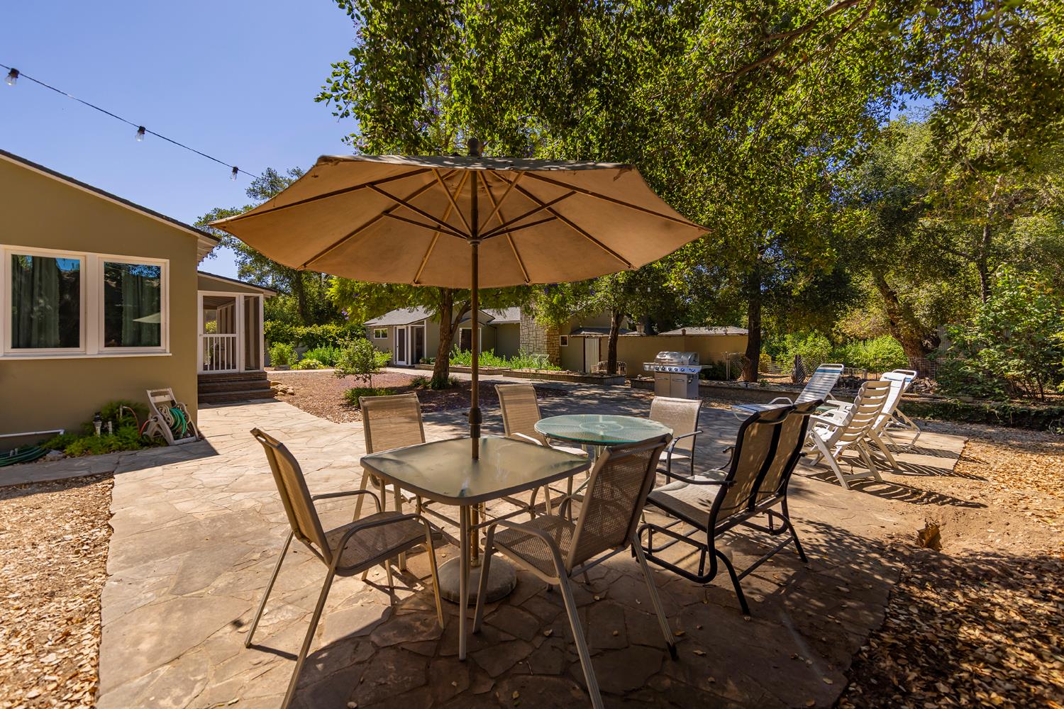 840 Fairview Road Ojai, CA 93023 - Photo 13 of 30 a view of patio with chairs and table under an umbrella