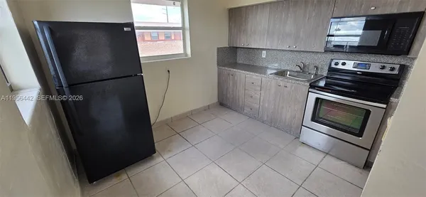 a kitchen with stainless steel appliances a refrigerator stove and microwave