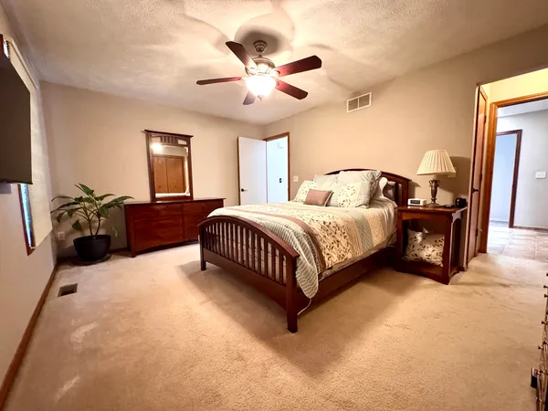a bedroom with a bed and ceiling fan