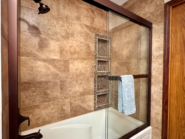 a bathroom with a bathtub and shower