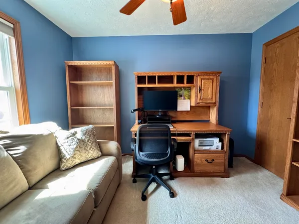 a workspace with furniture and window