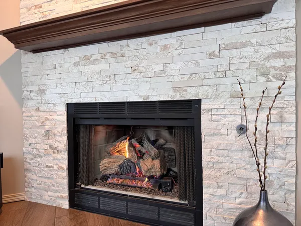 a fireplace with a clock on wall