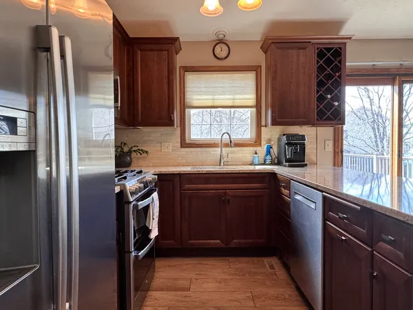 a kitchen with a refrigerator and a sink