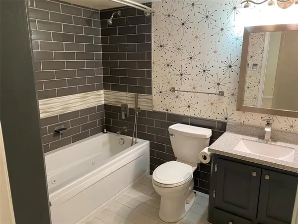 a bathroom with a toilet a sink and bathtub