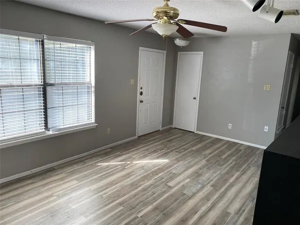 a view of a room with a ceiling fan and a window