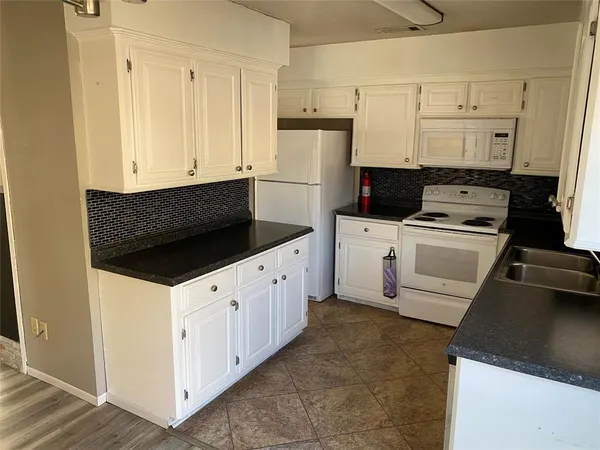 a kitchen with cabinets and appliances