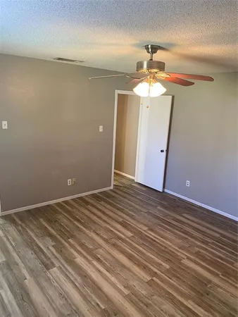 a view of a room with wooden floor