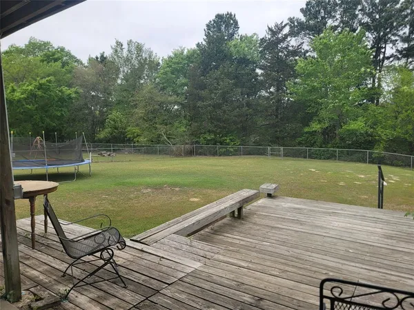 a view of a lake with a bench and trees around