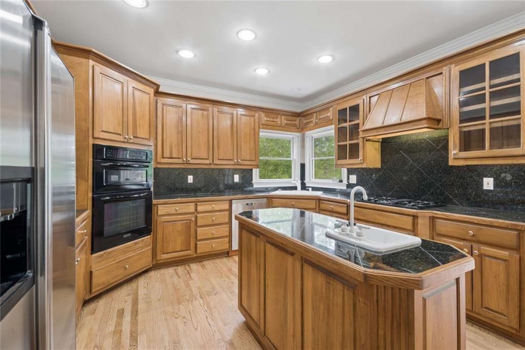2628 High Street Southwest Conyers, GA 30094 - Photo 17 of 53 a kitchen with granite countertop a sink stainless steel appliances and cabinets